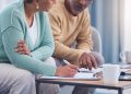 Senior couple, documents and sign contract for life insurance or home mortgage. Discussion, signature and retired elderly man and woman signing legal paperwork for will or loan application together.